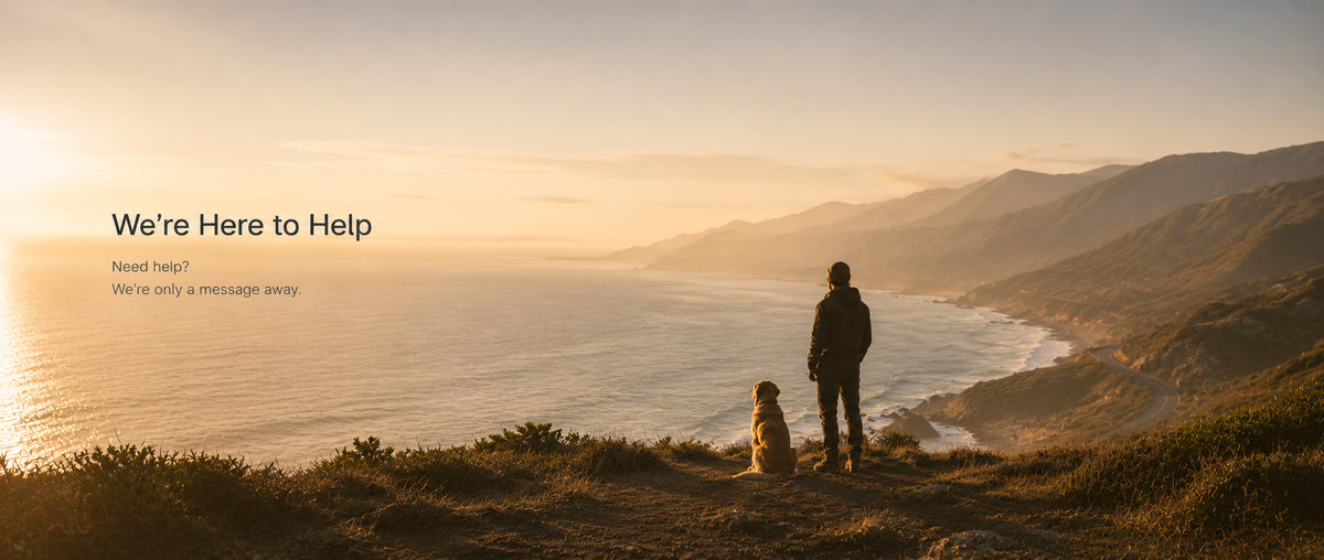 Person and dog sitting on a cliff overlooking the ocean with 'We're Here to Help' text overlay.