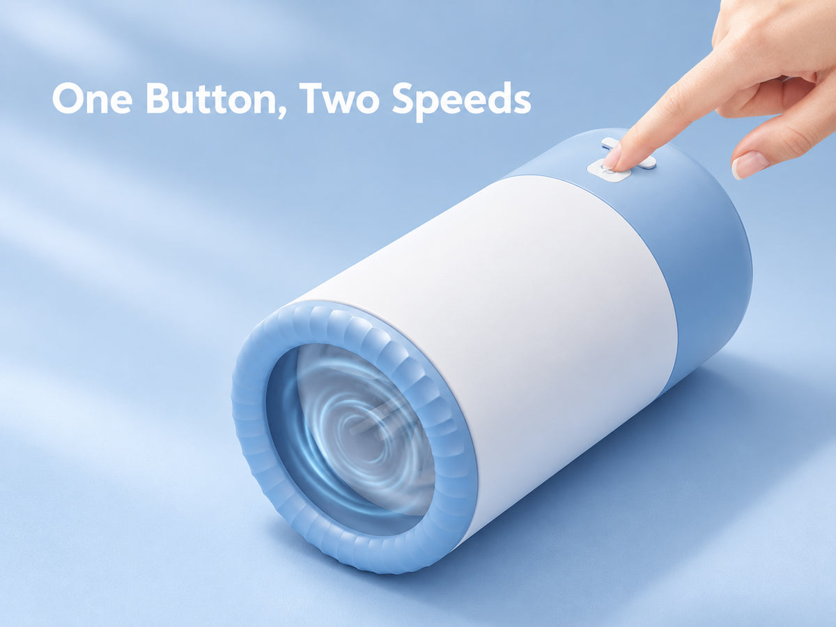 Blue and white electric dog paw cleaner with a finger pressing the power button, demonstrating its two cleaning speeds.