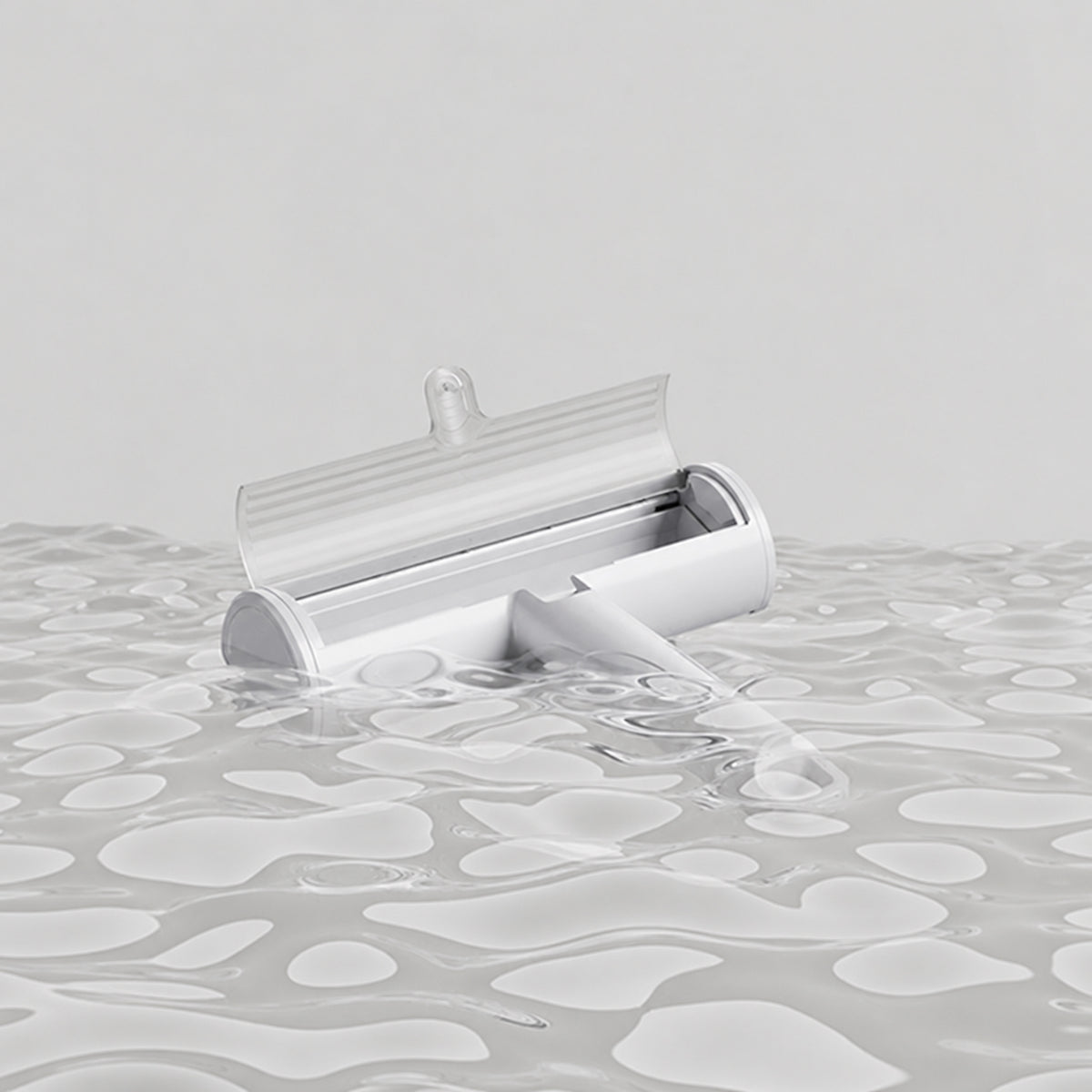 Reusable Pet Hair Remover Brush with open hair chamber in water during cleaning
